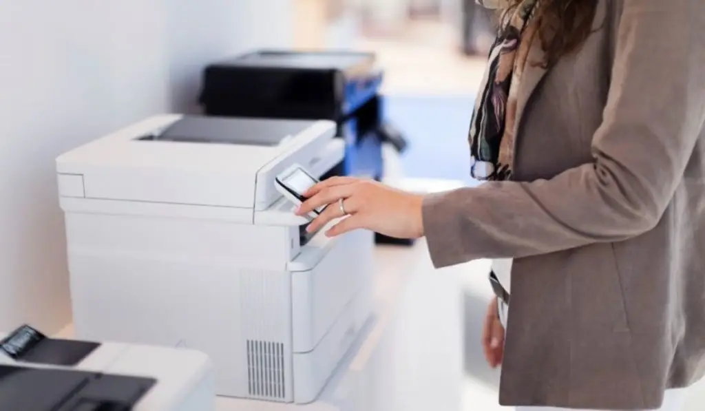 woman in an office using a printer machine
